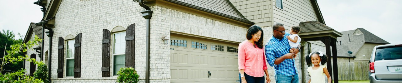 Family standing in front of their home